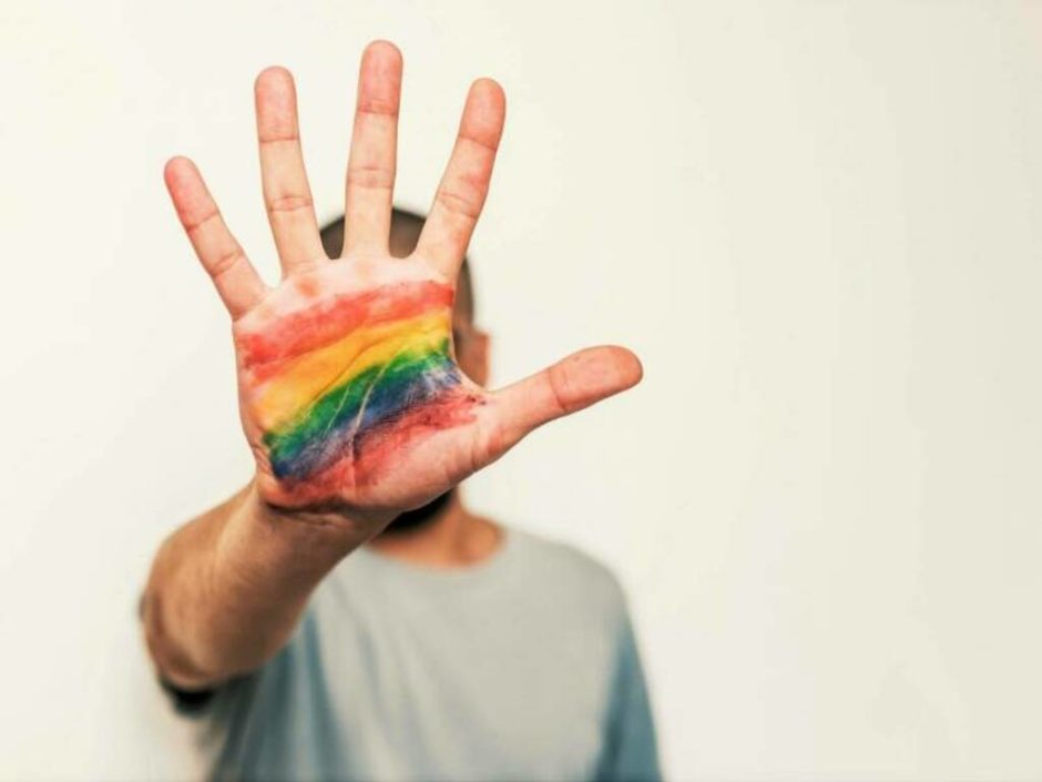 rainbow colour painted on a hand, homophobia colour 