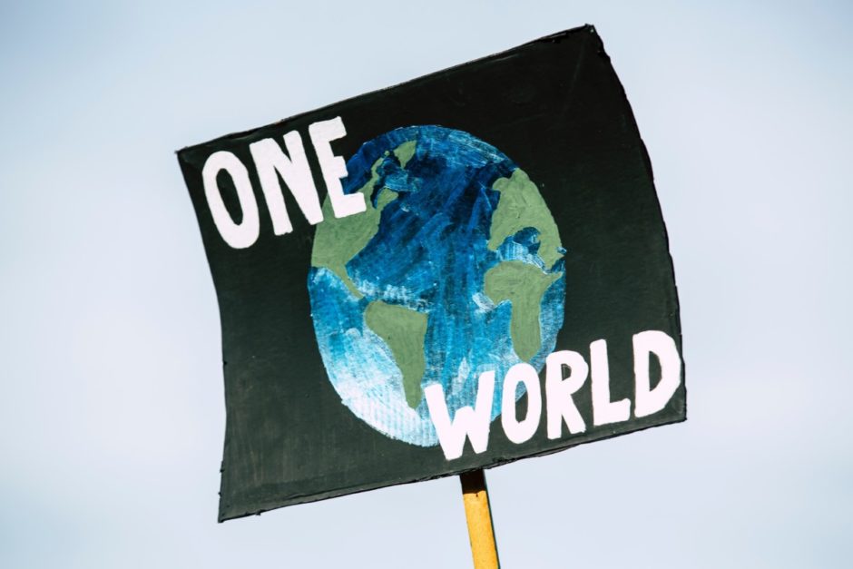 Protest sign that says „one world“ 
